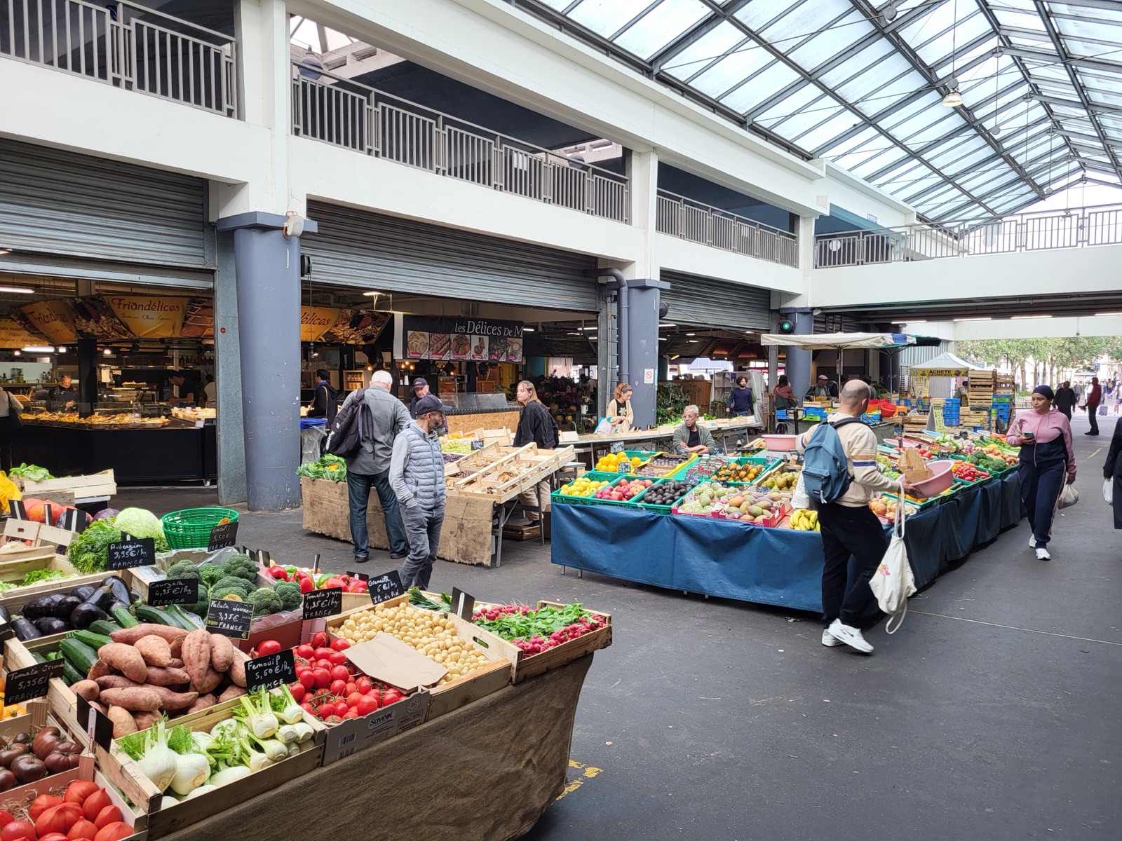 Interior of the Marché des Capucins in Bordeaux, with its fruit and vegetable stalls and glass roof